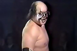 Japanese wrestler Kazuo Sakurada stands in ring wearing face paint.